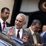 Iraq's fugitive Vice President Tareq al-Hashemi gestures as he leaves a meeting in Ankara