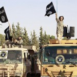 Militant Islamist fighters wave flags as they take part in a military parade along the streets of Raqqa