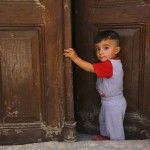 An Iraqi Christian boy fleeing the violence in the Iraqi city of Mosul, stands inside the Church of the Sacred Heart of Jesus Chaldean Church in Telkaif