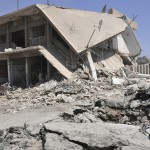 Residents inspect damage at a site which activists said was caused by a suicide bomber in the middle of a market last night in Tirbespiye village, east Qamishli