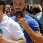 Iraqi Christians displaced by the violence in their country wait in line to receive aid from a Chaldean Catholic Church truck in Beirut