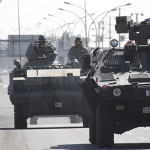 Turkish soldiers in armoured vehicles patrol the streets of Diyarbakir