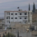 An Islamic State flag is seen in east Kobani