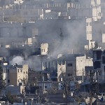 A view shows smoke raising from a Kobani neighbourhood damaged by fighting between Islamic State militants and Kurdish forces