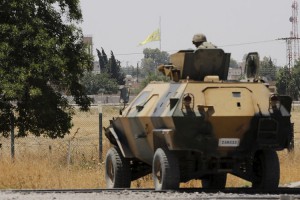 A Kurdish People's Protection Units (YPG) flag flies 