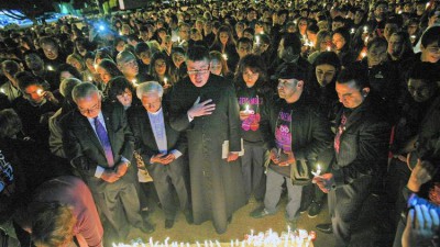 The Genocide Memorial is blessed at a candlelight vigil in the parking lot of the Glendale Civic Auditorium last April after a ceremony sponsored by United Young Armenians. (Tim Berger / Staff Photographer)