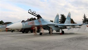 Russian servicemen prepare a Sukhoi Su-30SM fighter jet before a departure for a mission at the Hmeimin military base in the Latakia province, in the northwest of Syria, on December 16, 2015. (AFP)