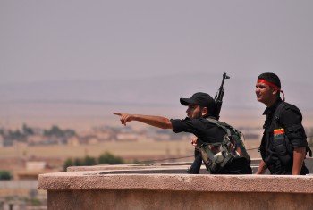 Fighters from the Kurdish People Protection Unit (YPG) monitor the horizon in the northeastern Syrian city of Hasakeh 