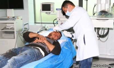 Yevand Firian, an Armenian Karabakh farmer receives medical treatment after being injured Azerbaijani rocket fire on 26 March.