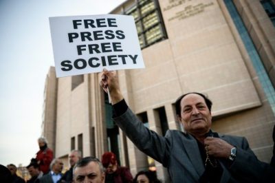 © AFP/File | A demonstrator holds a placard reading "Free Press Free Society", outside the Istanbul courthouse on April 1, 2016