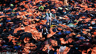 Volunteers walk on a pile of lifejackets left behind by refugees and migrants who arrived to the Greek island of Lesbos after crossing the Aegean Sea from Turkey last year Read more: http://www.dailymail.co.uk/news/article-3606168/Turkey-deliberately-selecting-uneducated-sick-Syrians-Europe-cherry-picking-wants-keep.html#ixzz49l6Udxnw  Follow us: @MailOnline on Twitter | DailyMail on Facebook