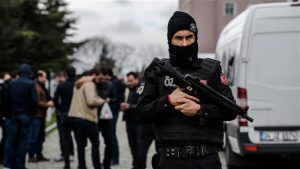 A Turkish anti-riot police officer stands guard in front of the headquarters of Turkish daily newspaper Zaman in Istanbul on March 5, 2016. © AFP