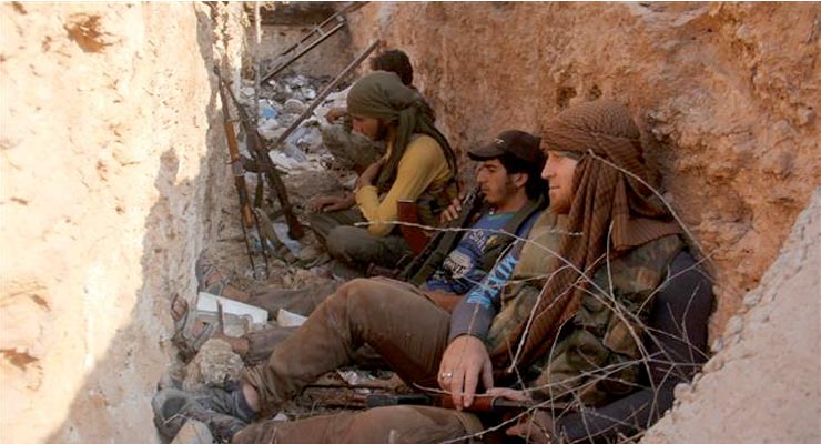 This picture taken on August 6, 2016 shows members of the Jabhat Fateh al-Sham terrorist group sitting in a trench in the northern Syrian city of Aleppo. ©AFP