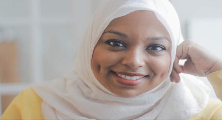 A Toronto television journalist is believed to be Canada's first anchor to don a Muslim head scarf 