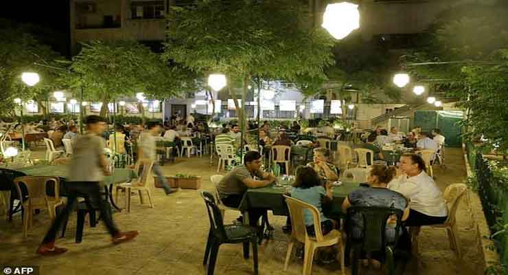 Syrians from Aleppo's Armenian community have dinner at a cafe in the Midan neighbourhood of the northern Syrian city on July 5, 2017