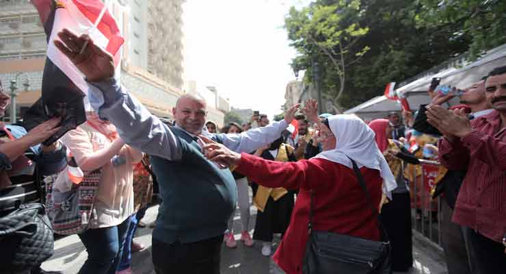 A man and a woman dance outside Qasr al-Dubara polling station in Downtown Cairo on March 27, 2018 - Ahmed Hindy